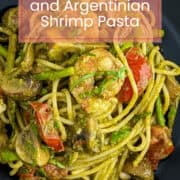 Jalapeño pesto pasta with Argentinian shrimp, tomatoes, and asparagus in a vibrant presentation.