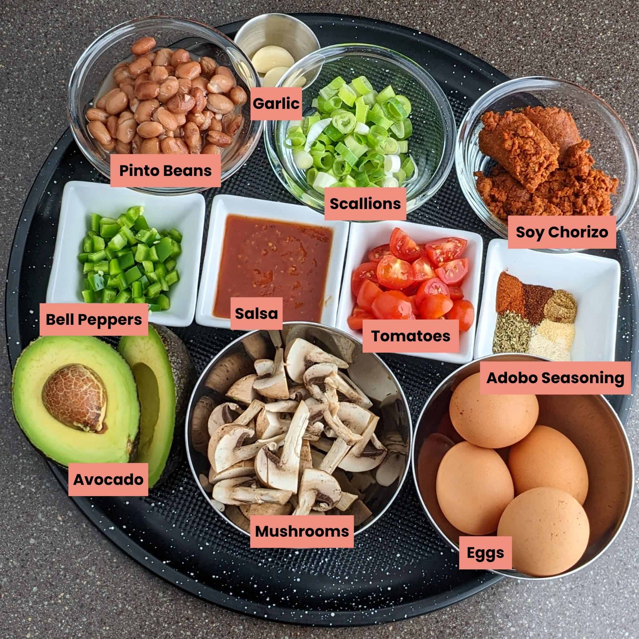 labeled ingredients for the Piquant Chorizo Beans and Eggs Skillet on a round tray.
