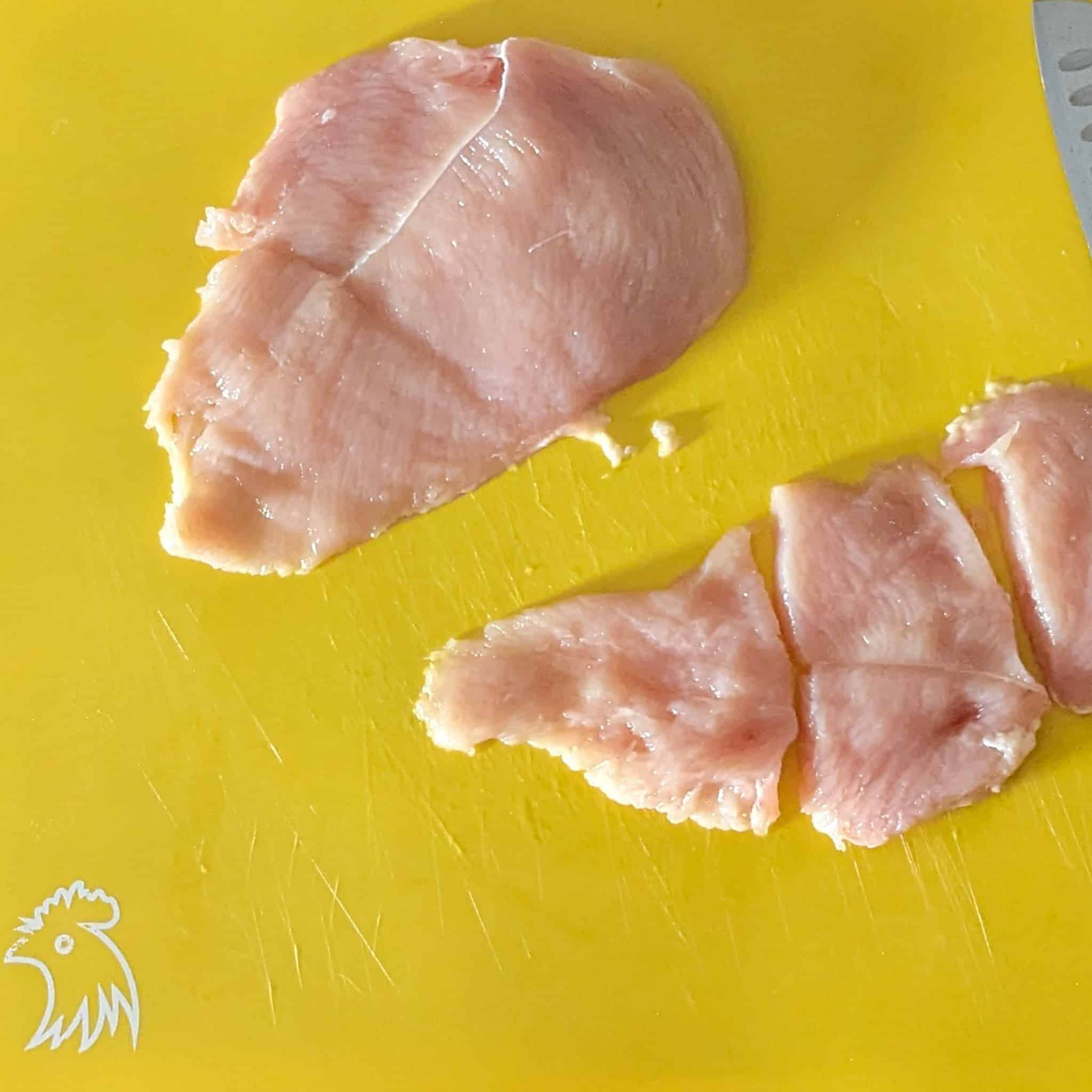 a butterflied chicken that has been divided into two with one half cut into thirds for small chicken cutlets