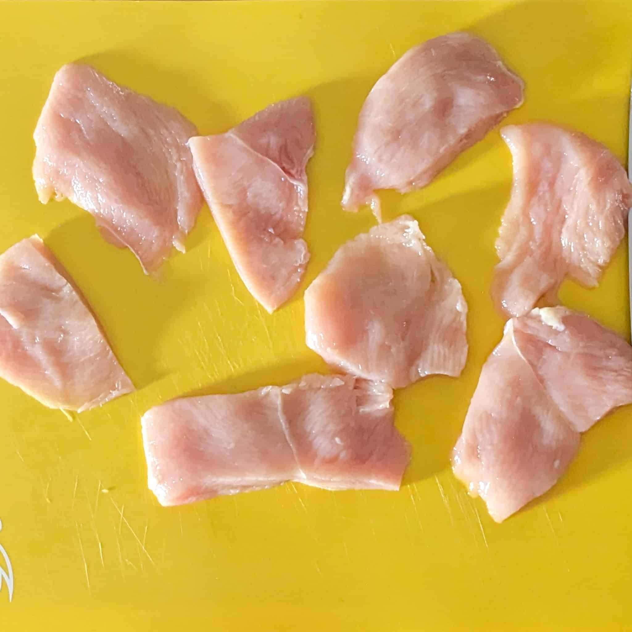 small chicken cutlet pieces on a cutting board