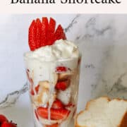Delicious strawberry and banana shortcake parfait with whipped cream and fresh fruit layers.