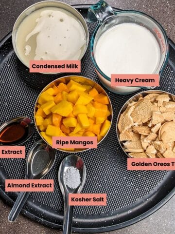 ingredients for the mango cookies and cream no churn ice cream on a round tray.