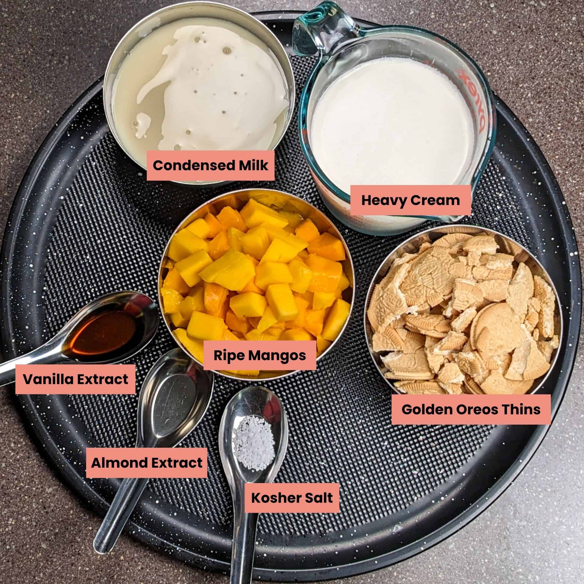 ingredients for the mango cookies and cream no churn ice cream on a round tray.