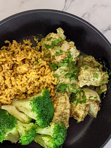 zhug chicken in a bowl with spiced rice and broccoli