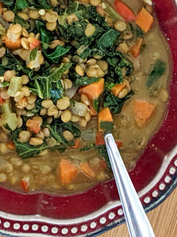 lentil stew in a read bowl