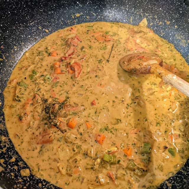 spicy red bean stew roux base in a dutch oven with a wooden spoon