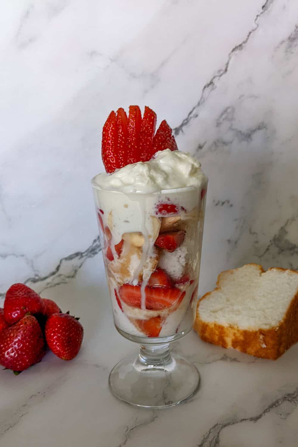 Delicious strawberry and whipped cream parfait layered with cake, perfect for summer desserts.