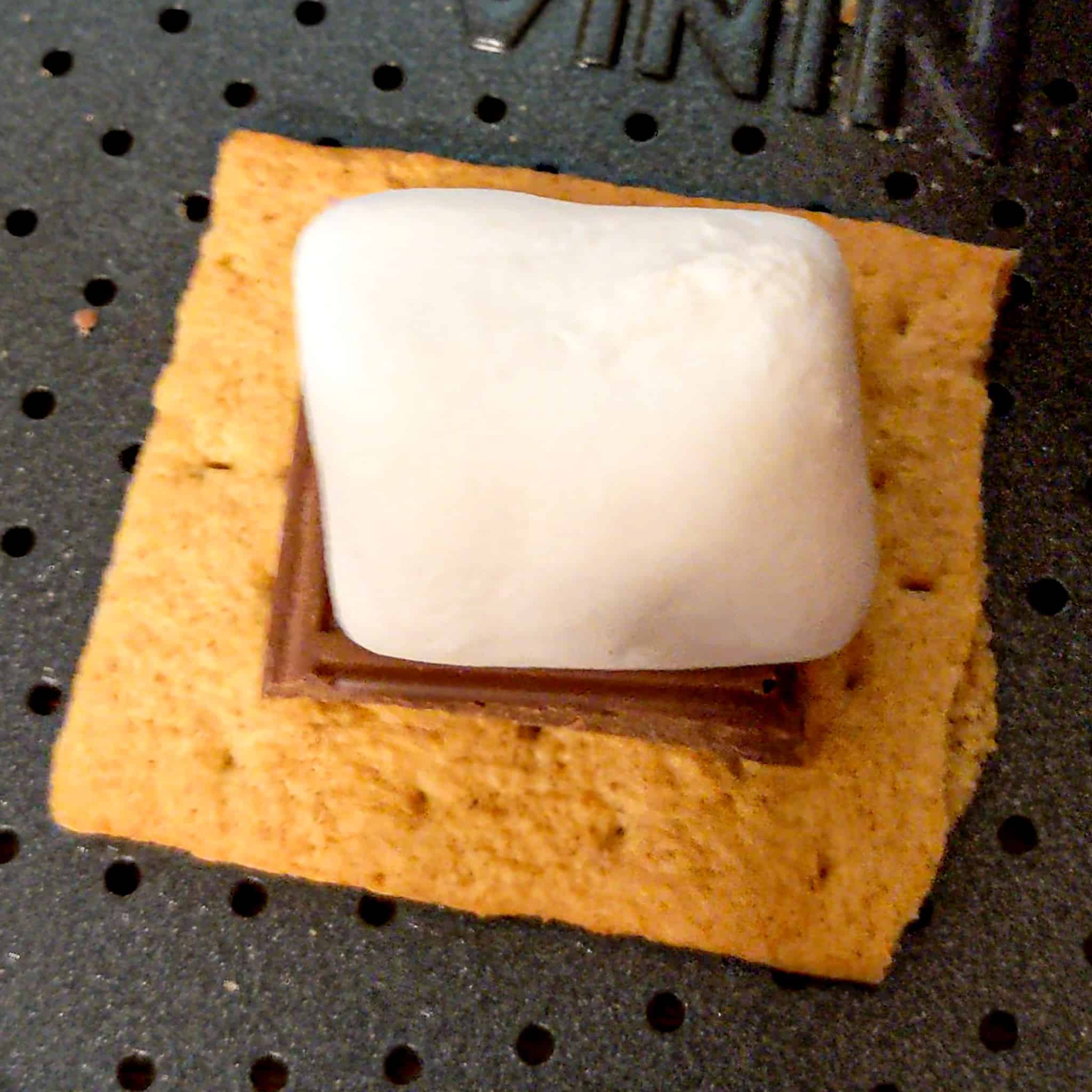 honey maid graham cracker with Hershey's milk chocolate and jet-puffed marshmallow for the air fryer s'mores cookies recipe on an air fryer tray