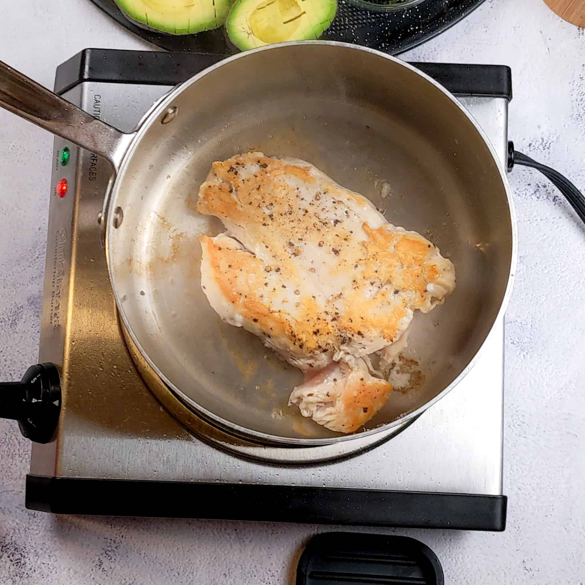 brown chicken breast in a large saucepan