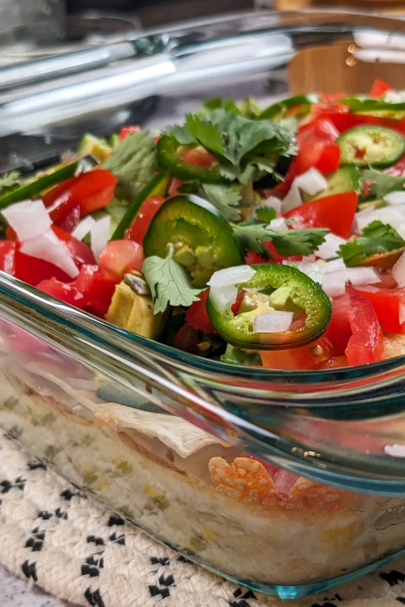 side view of the Chicken Tortilla Lasagna in the clear glass baking dish