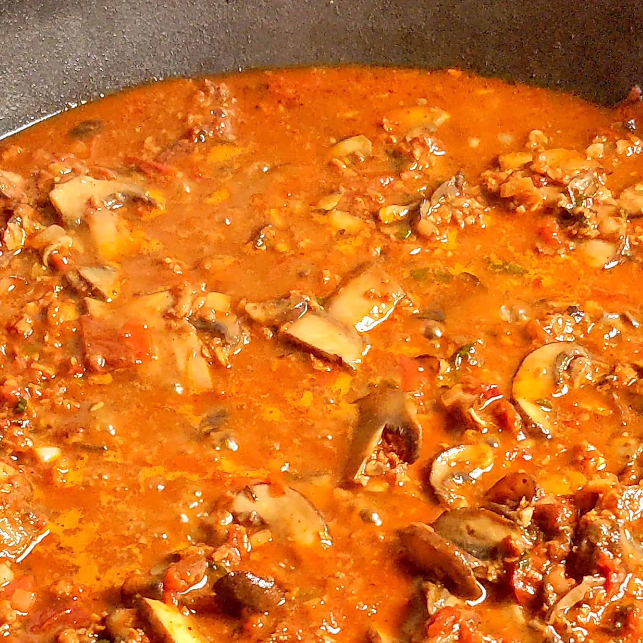 mushrooms and vegetables simmering in vegetable broth for the mushroom lentil bean chili