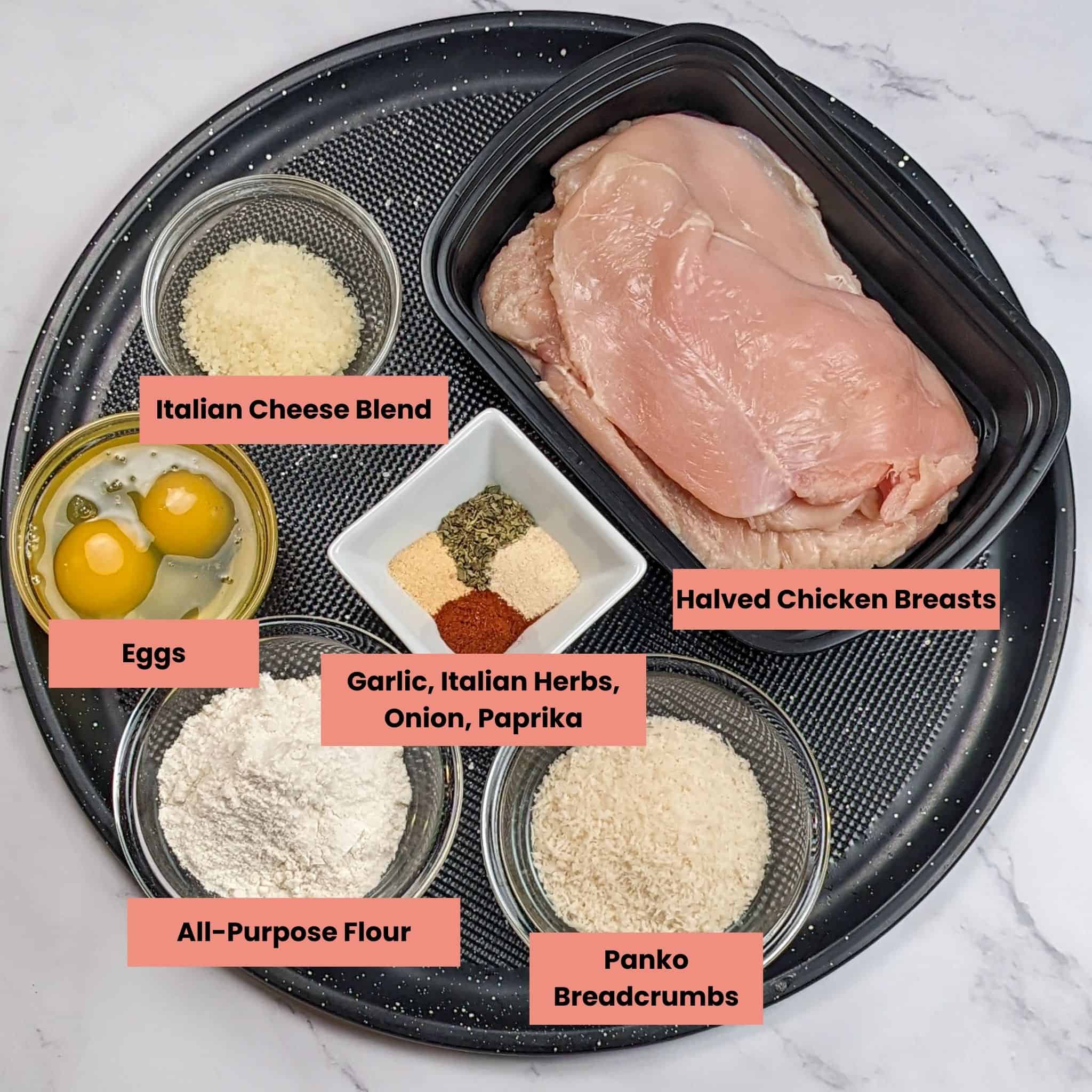 ingredients for the wet lemon pepper chicken cutlets in containers on a round pizza tray