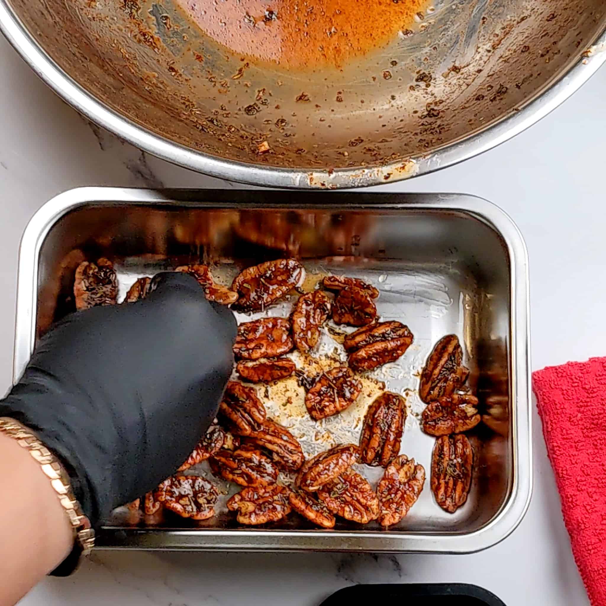 maple syrup seasoned coated pecans in a small metal deep baking tray