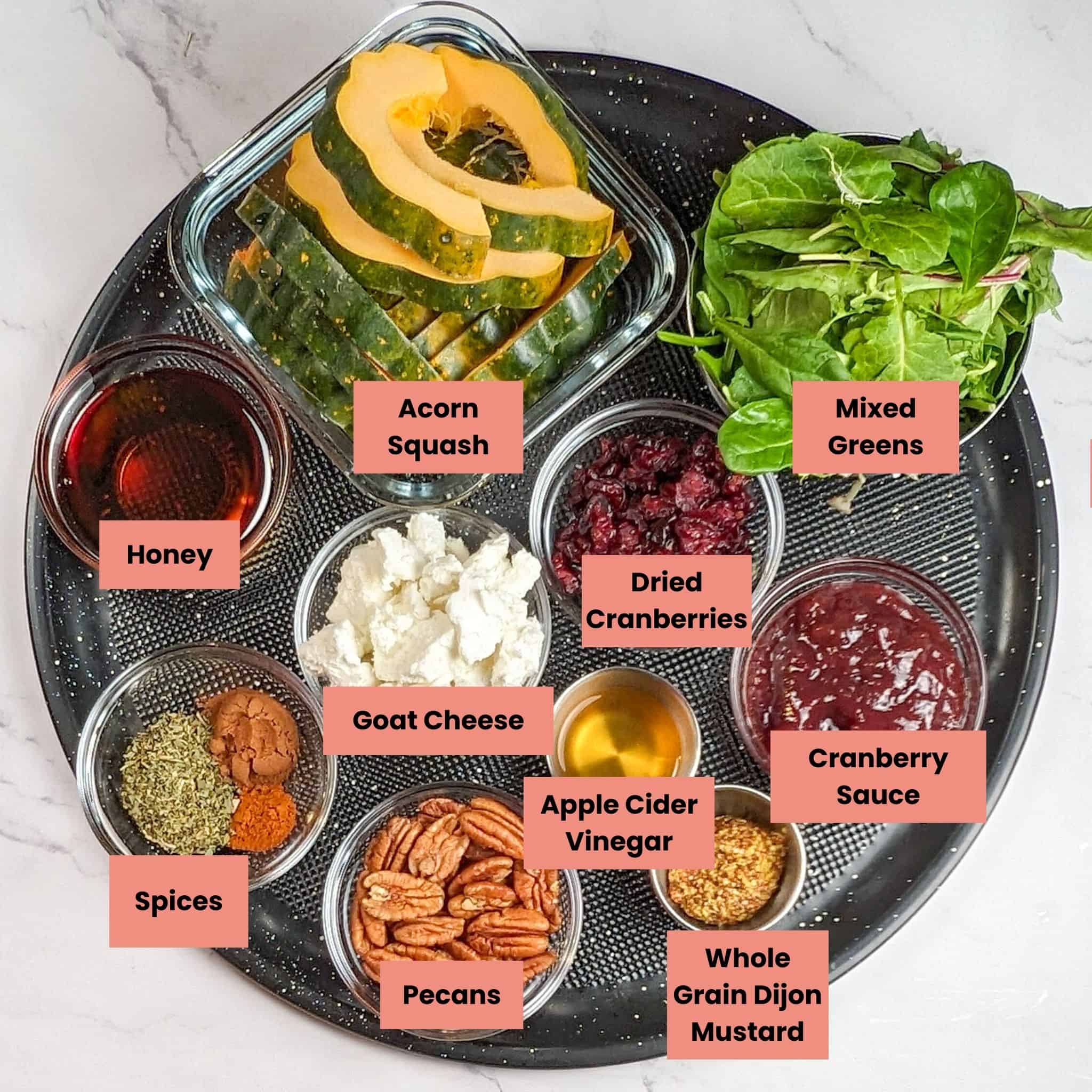 ingredients in containers on a large pizza pan for the top view of the Chicken Paillard with Cranberry Pecan Acorn Squash Salad