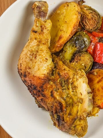 top view of the Curry spatchcocked chicken with vegetables plated in a large wide round bowl