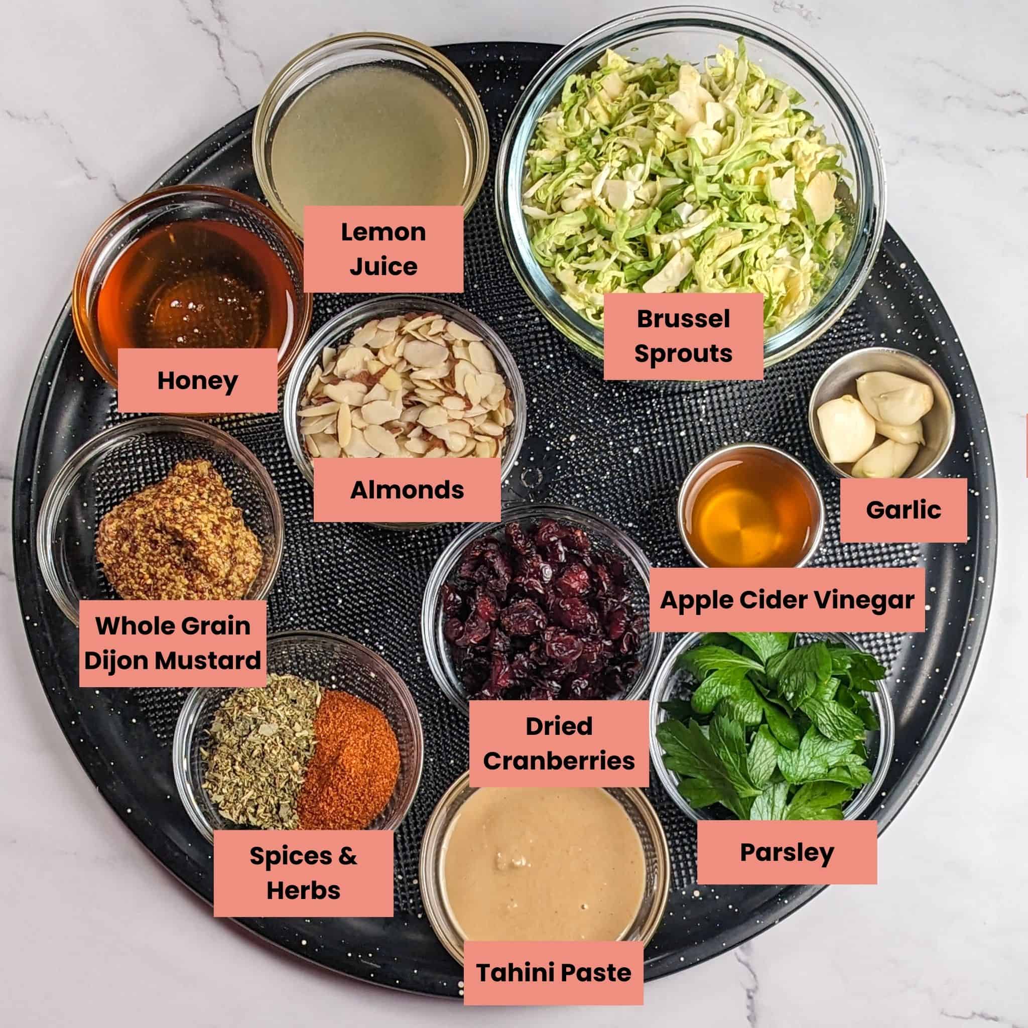ingredients for the Honey Dijon Chicken Rice Bowl in containers on a large round pizza pan