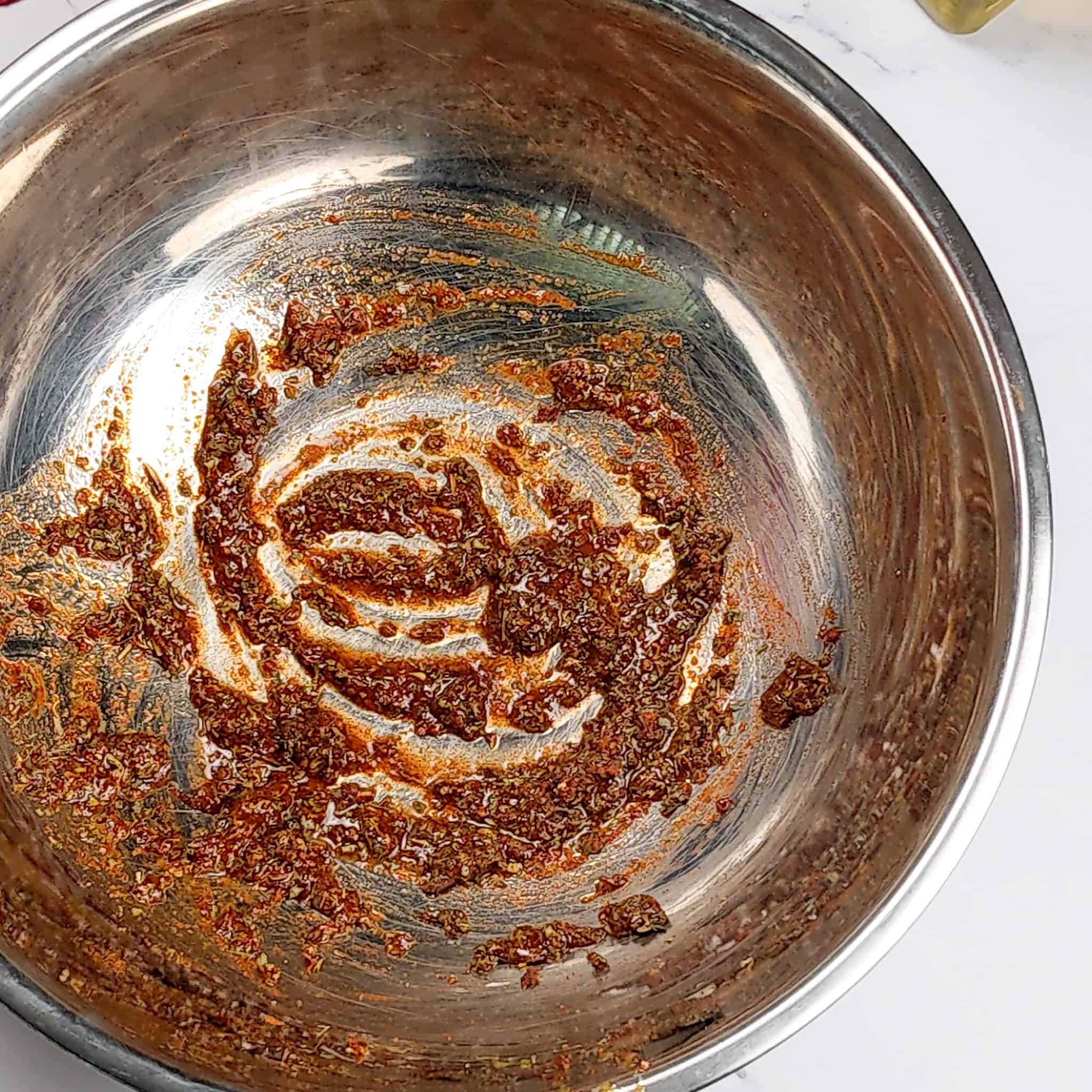 wet rub mixture in a large wide stainless steel mixing bowl