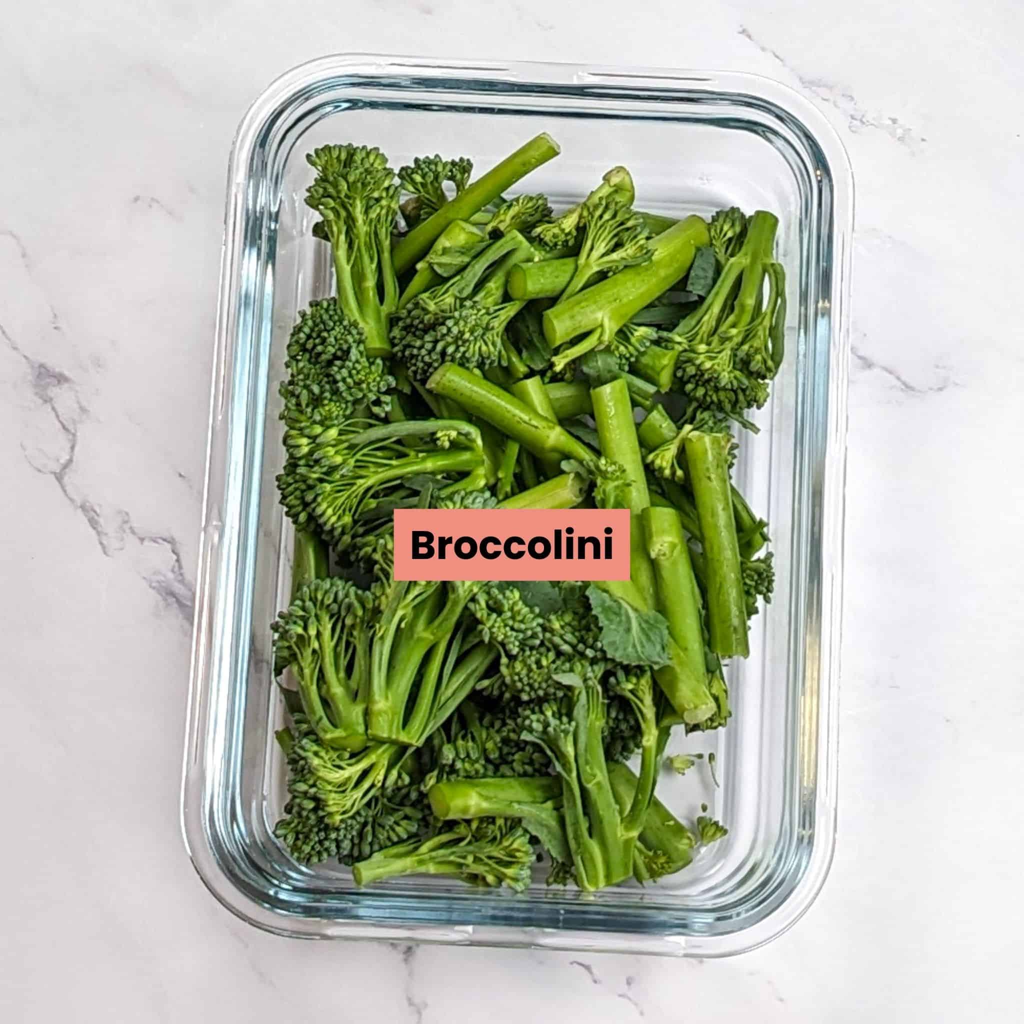broccolini cut into thirds in a rectangular glass container