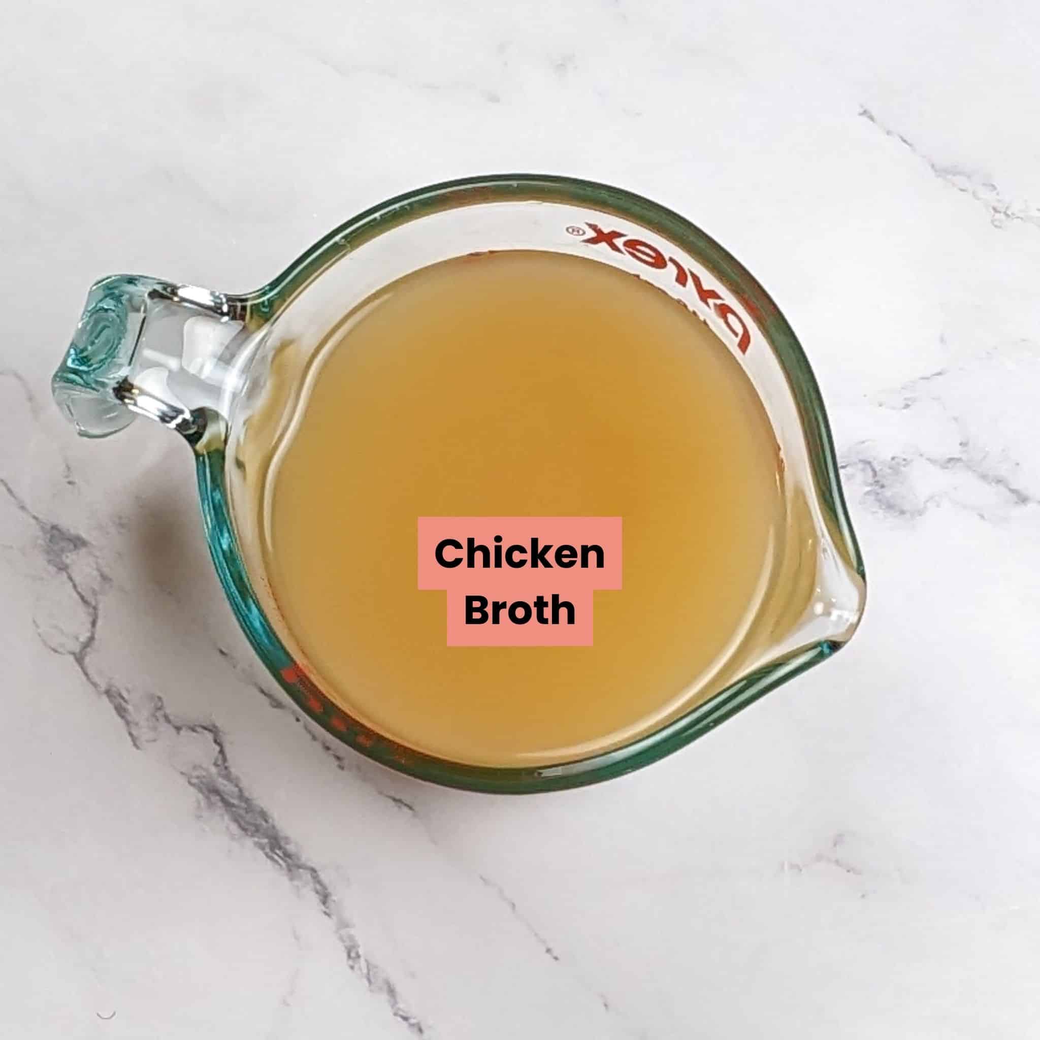 top view of chicken broth in a pyrex measuring cup