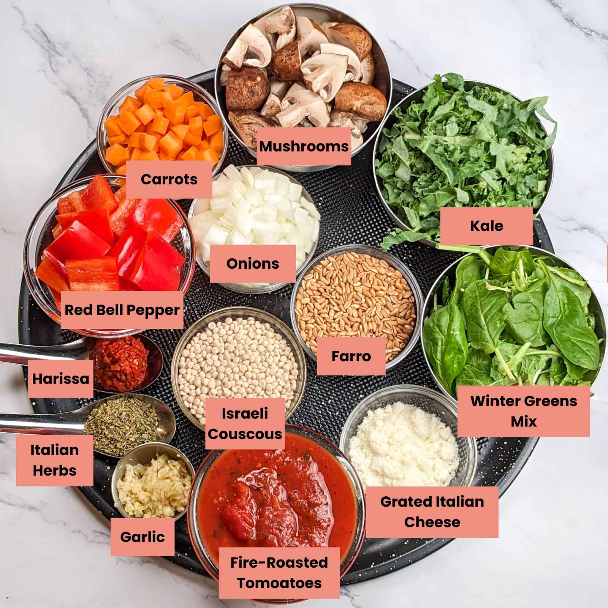 ingredients for the easy spicy italian chicken sausage soup with farro and israeli couscous in containers on a round large pizza pan.