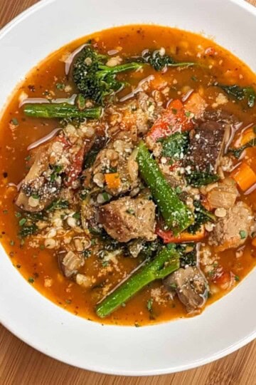 top view of the plated easy spicy italian chicken sausage soup with farro and israeli couscous
