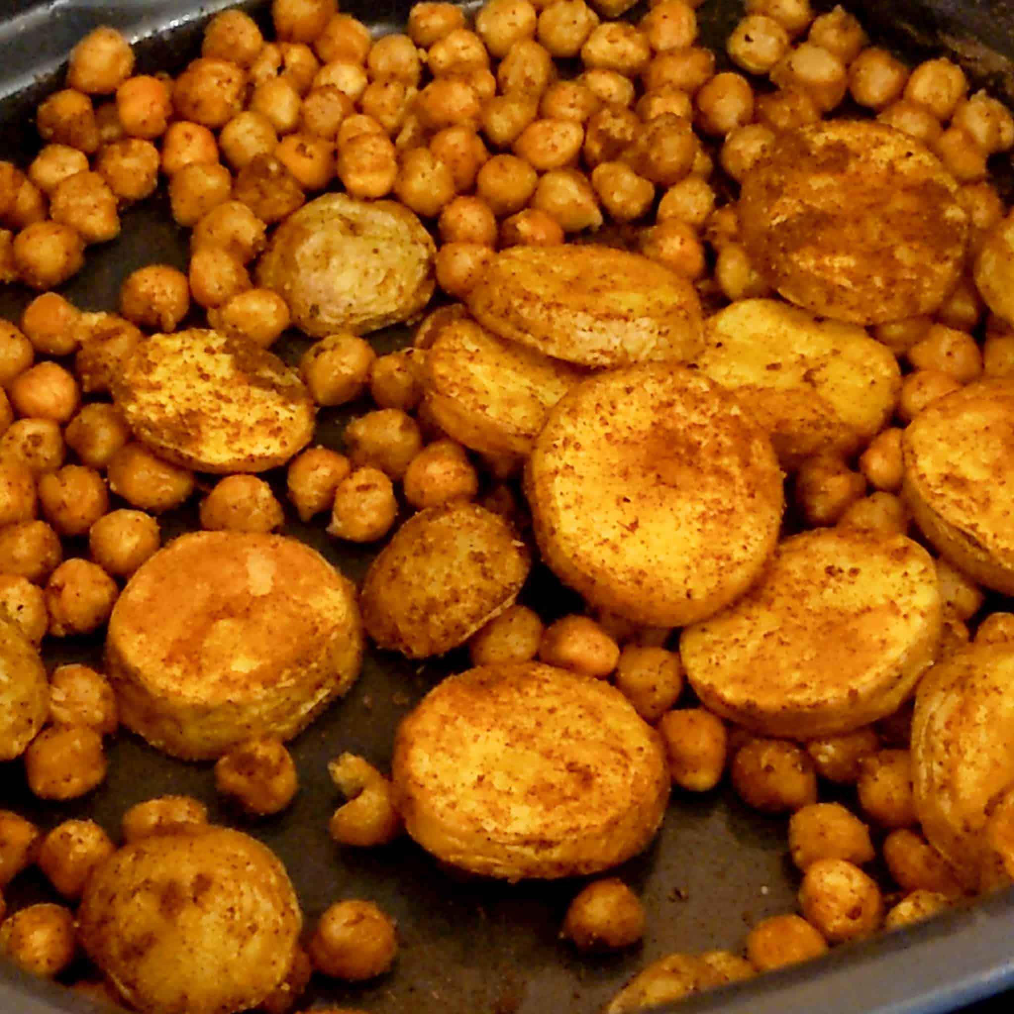 air fried roasted chickpeas and sliced baby Dutch yellow potatoes tossed in ras el hanout in an air fryer roasting pan attachment