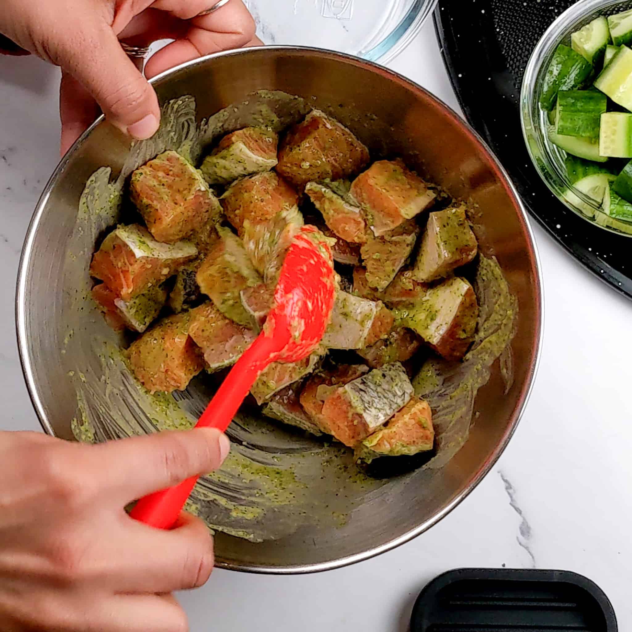 skin-on salmon chunks being coated with the Cilantro Lime dressing