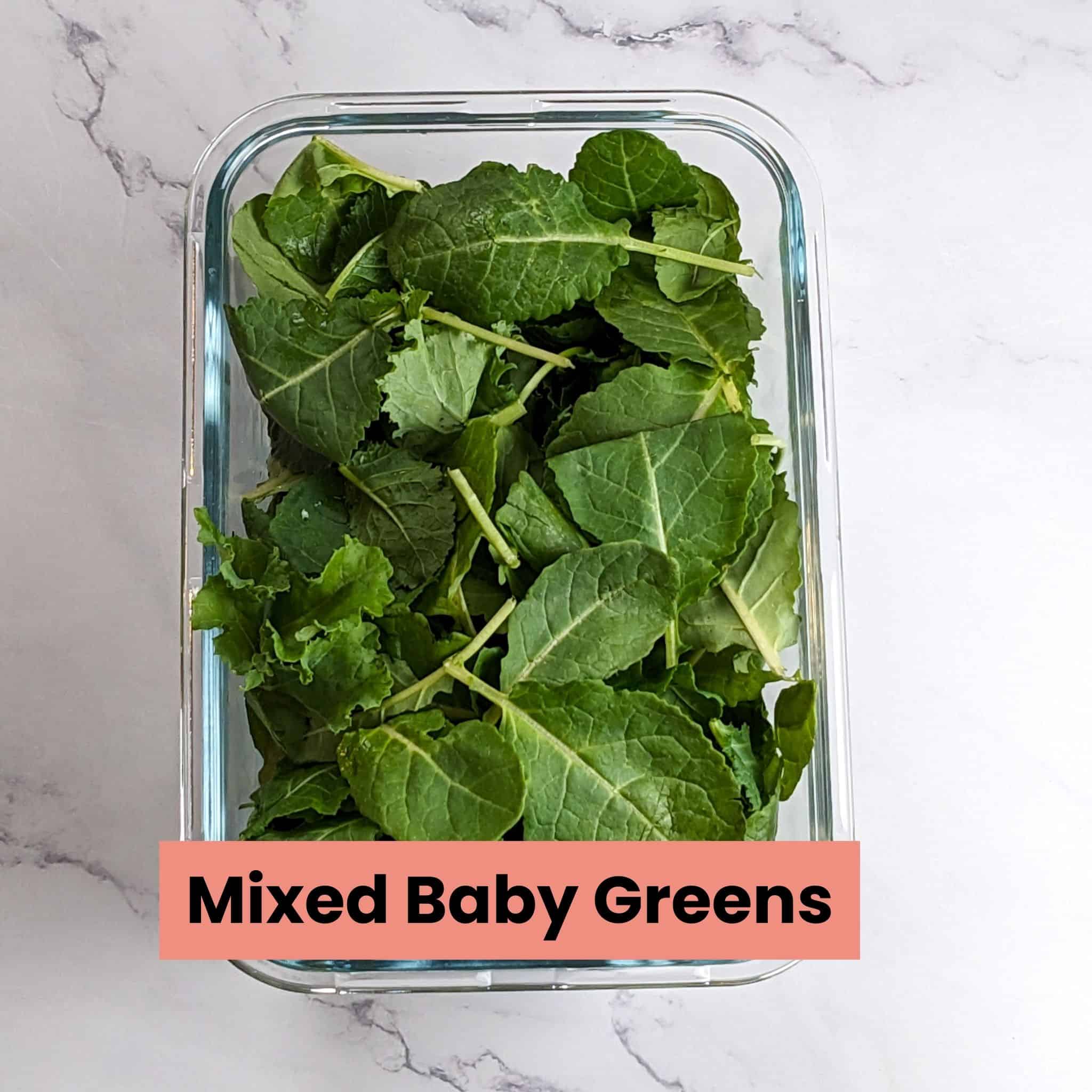 mixed baby greens in a rectangle glass deep container