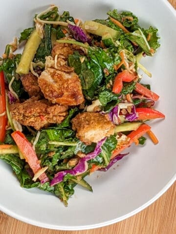 top view of the Sweet Chili Peanut Chicken Tenders Salad in a wide rim salad bowl