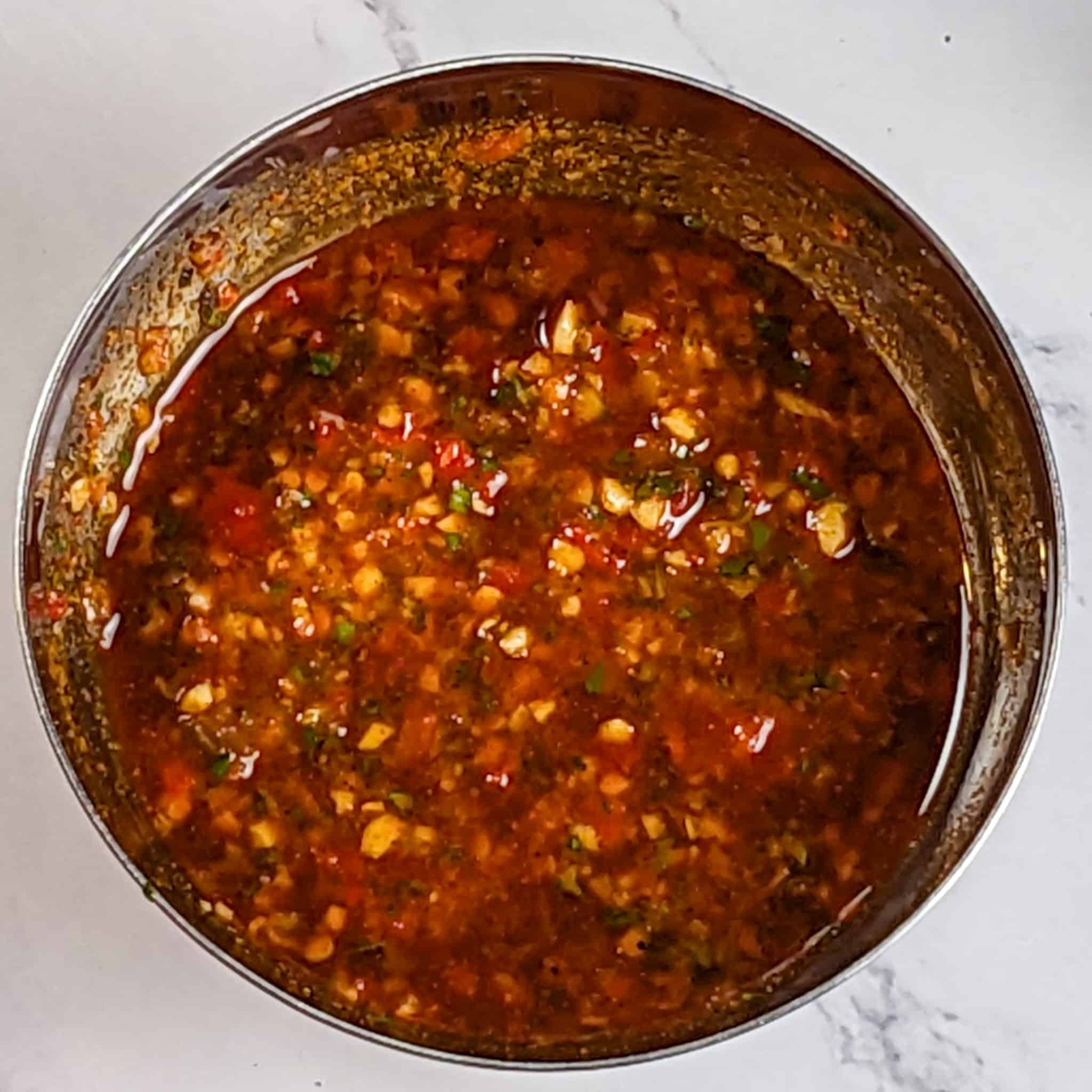 Calabrian pepper basil sauce in a small stainless steel mixing bowl