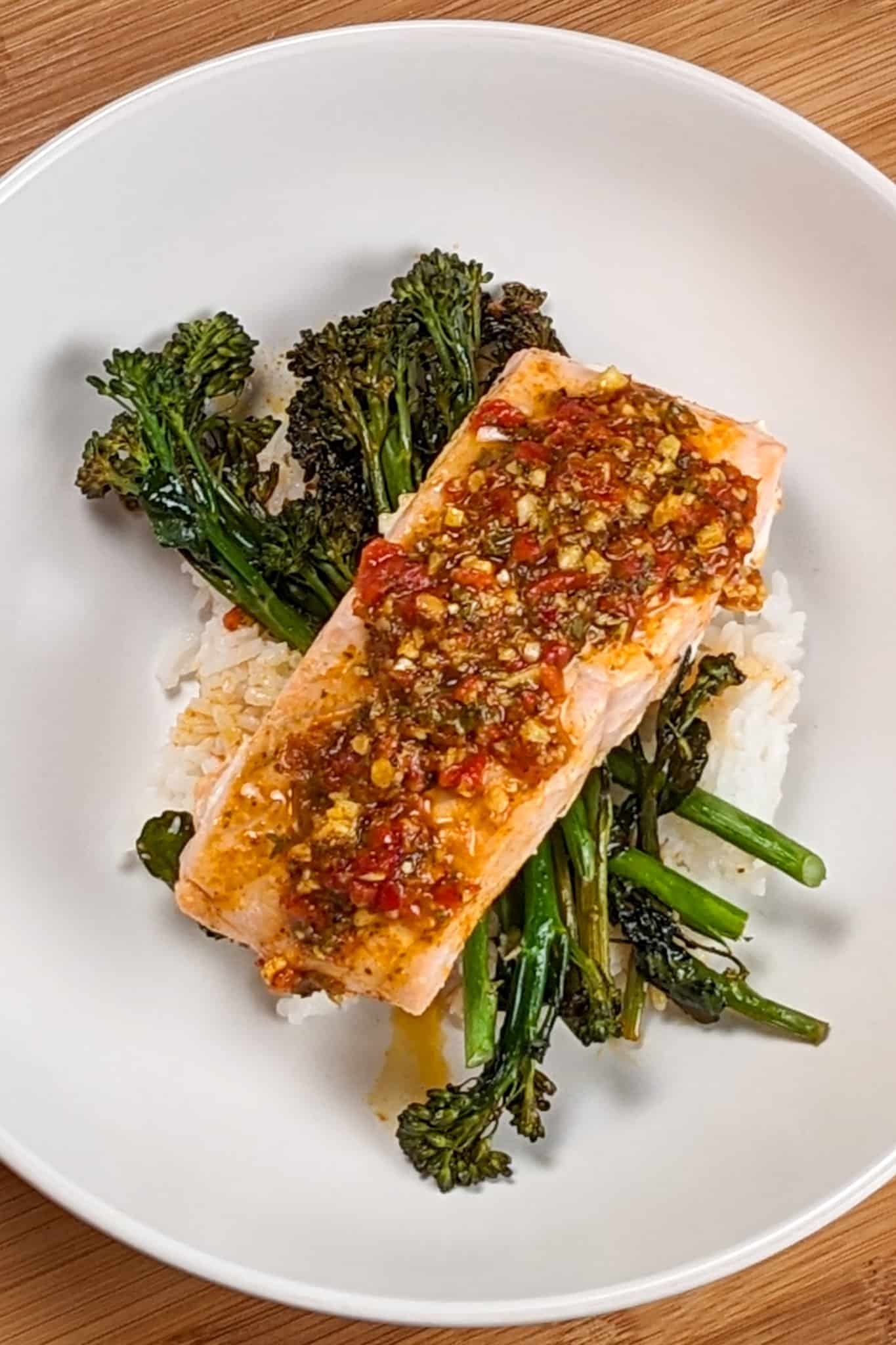 top view of the Calabrian Pepper Basil Baked Salmon and Broccolini in a wide round pasta bowl