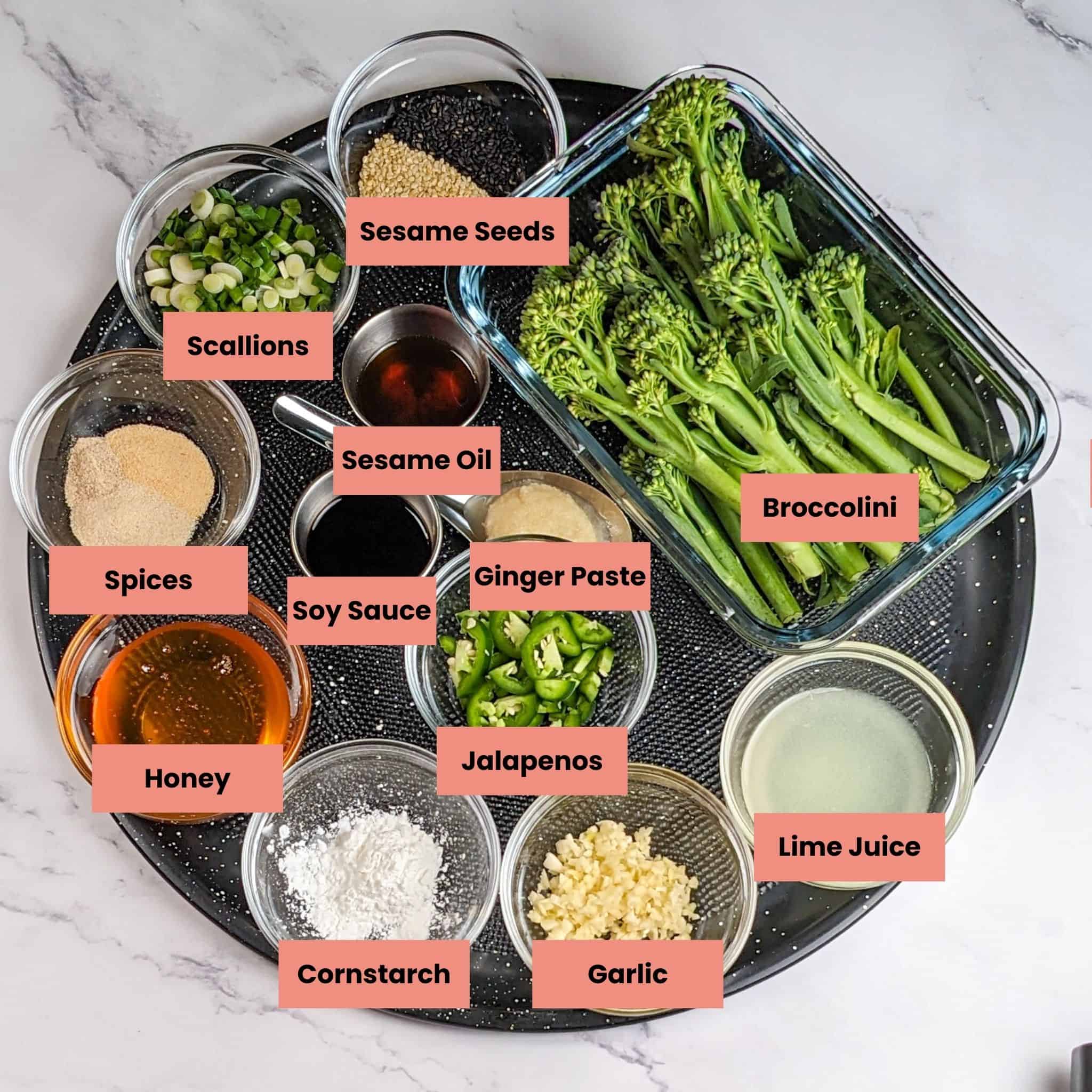 The Spicy Honey Jalapeno Lime Chicken with Broccolini recipe ingredients in containers on a large pizza pan.