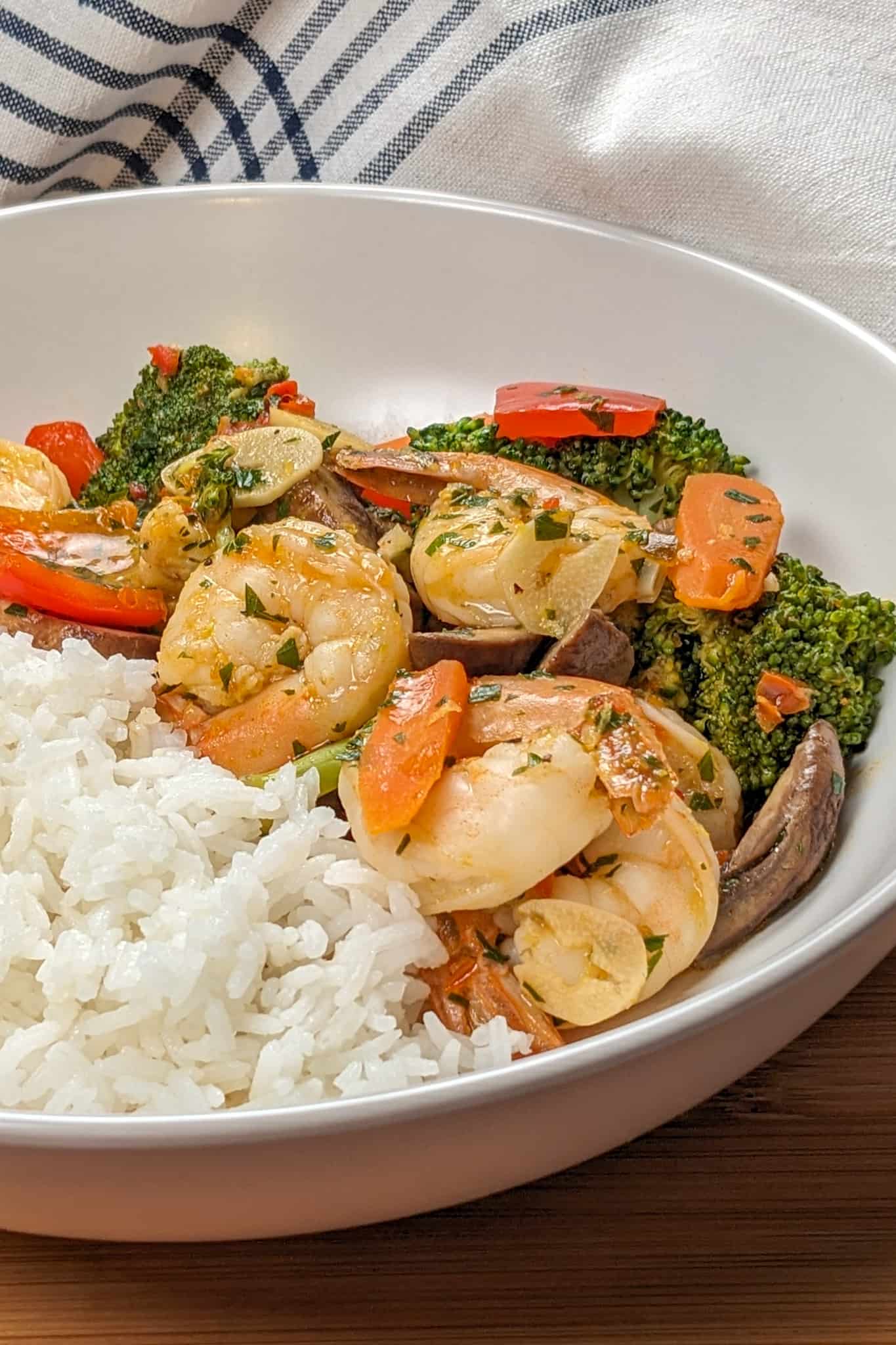 side view of the Best Spicy Sauteed Chili Lemon Garlic Shrimp and Vegetables in a round wide bowl