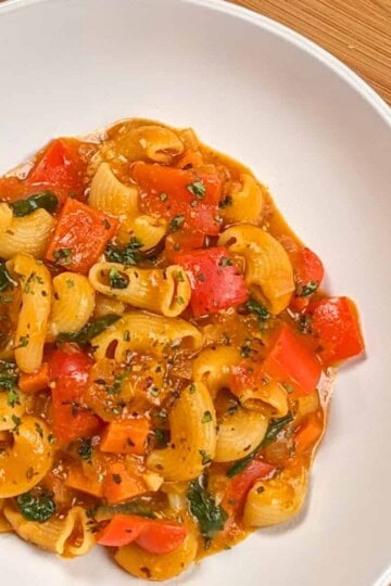 top view of the Macaroni Cheese Tomato Stew in a wide round deep bowl