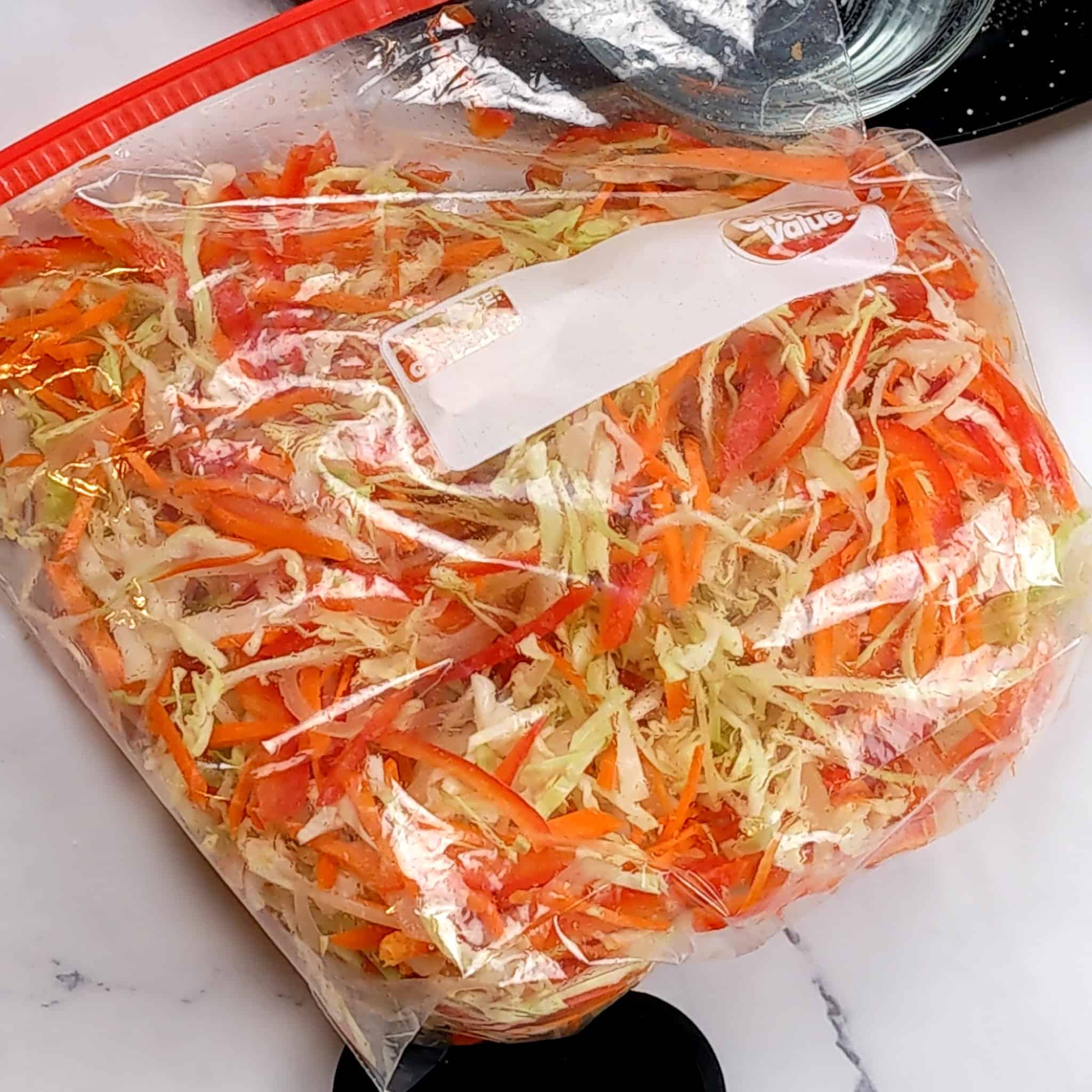 shredded vegetables with the scotch bonnet pepper citrus vinaigrette in a resealable zipper bag for the Best Air Fryer Caribbean Style Citrus Chicken Wings recipe