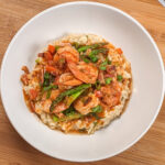 Top view of the Spicy Creole Shrimp and White Cheddar Cheese Risotto in a wide rim bowl.