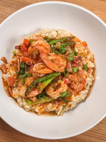 Top view of the Spicy Creole Shrimp and White Cheddar Cheese Risotto in a wide rim bowl.