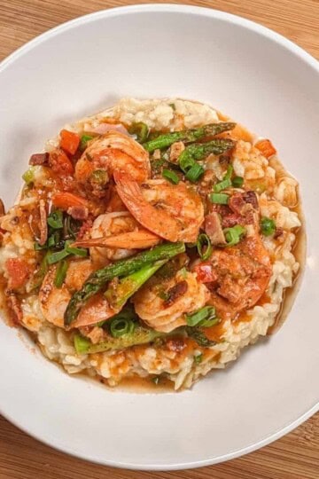 Top view of the Spicy Creole Shrimp and White Cheddar Cheese Risotto in a wide rim bowl.