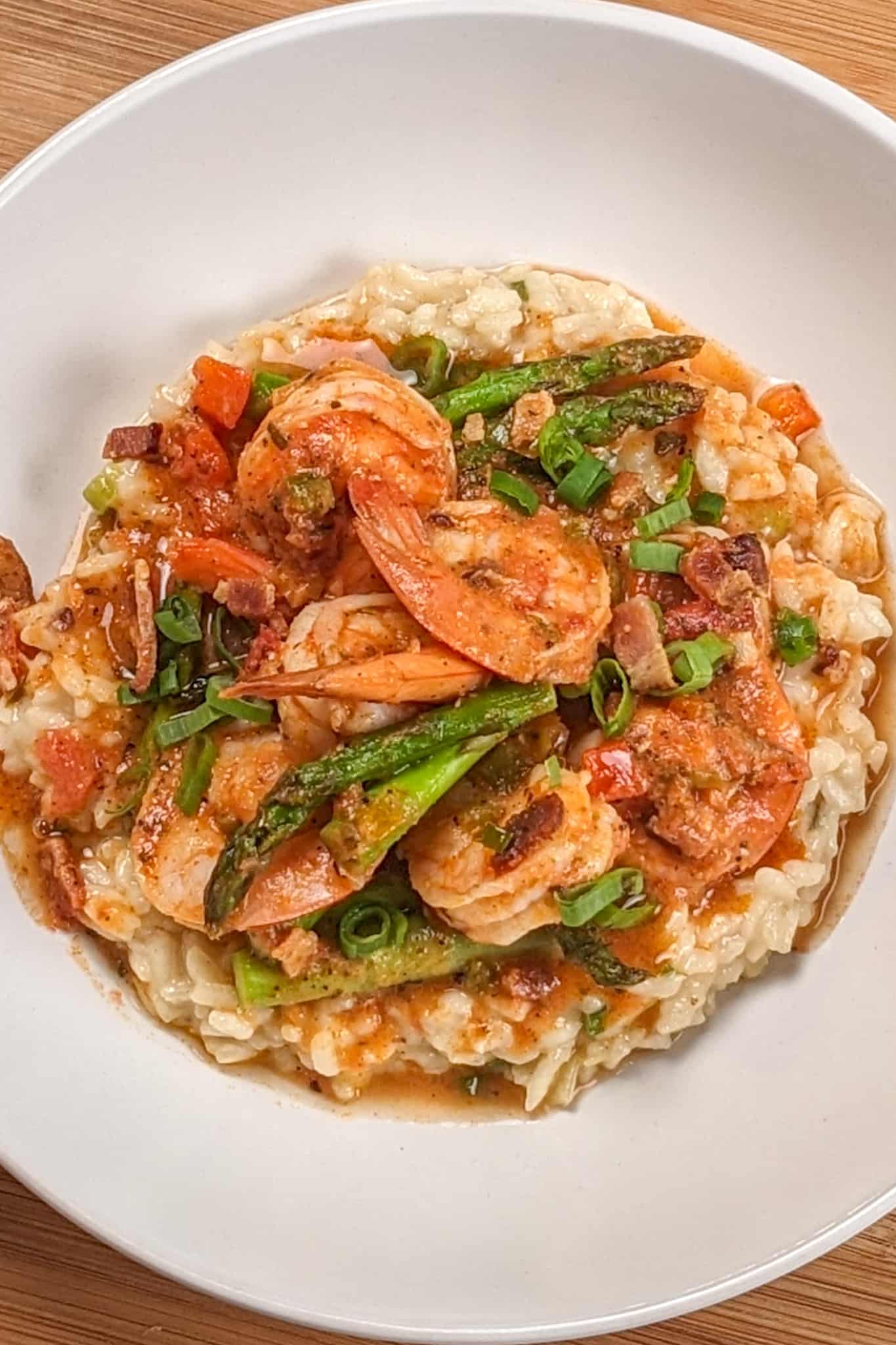 Top view of the Spicy Creole Shrimp and White Cheddar Cheese Risotto in a wide rim bowl.