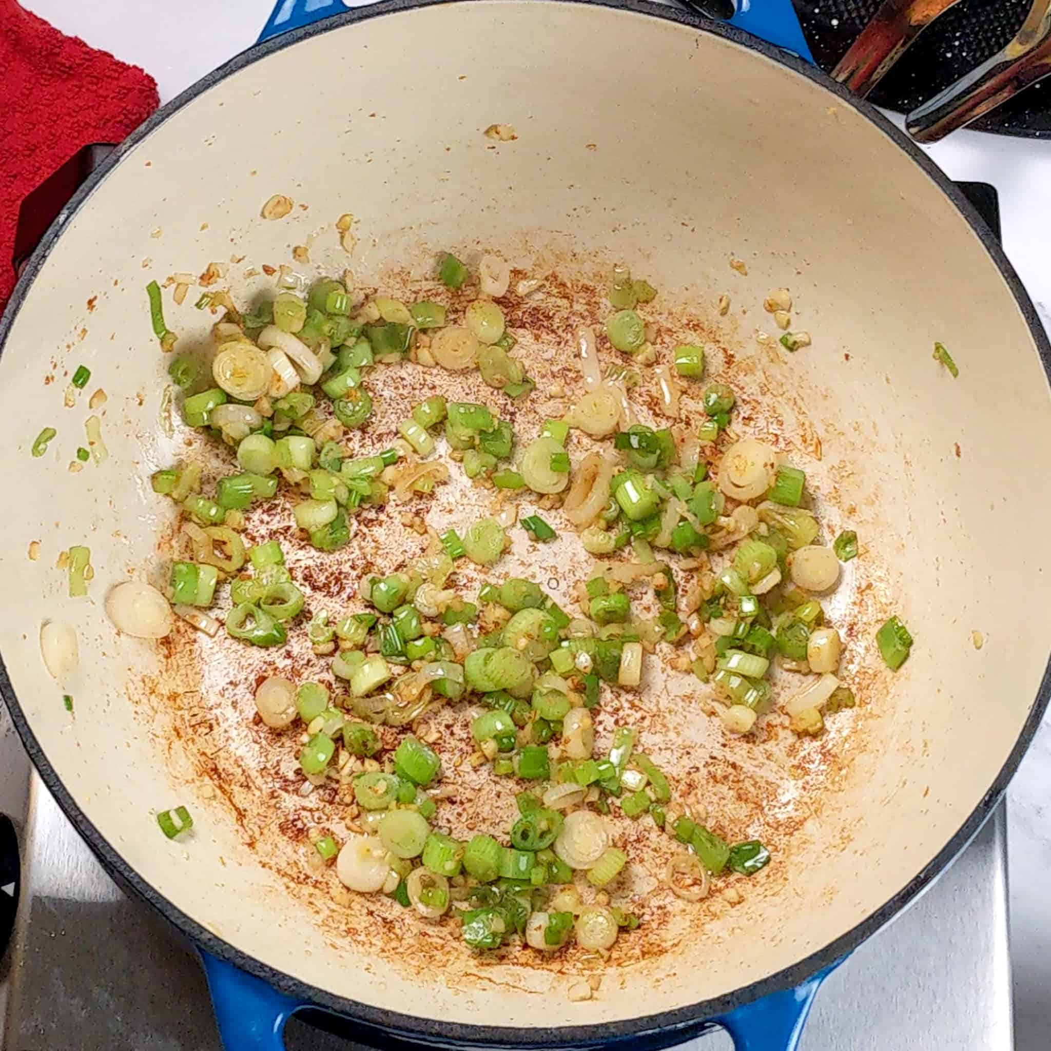 sliced scallion and garlic cooked in a dutch oven