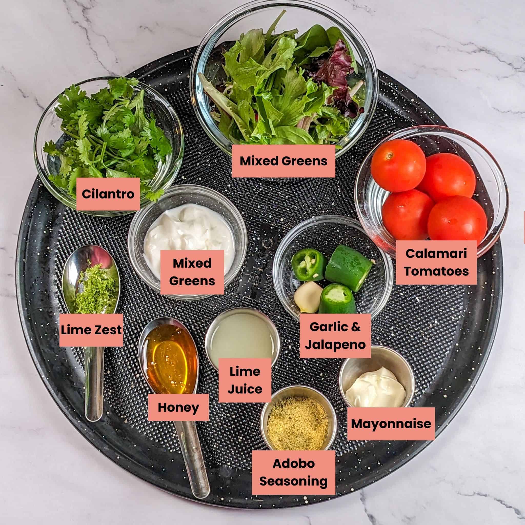 ingredients in containers for the Quick Air Fryer Lime Chicken Wings with Spicy Green Sauce recipe on a large round pizza pan