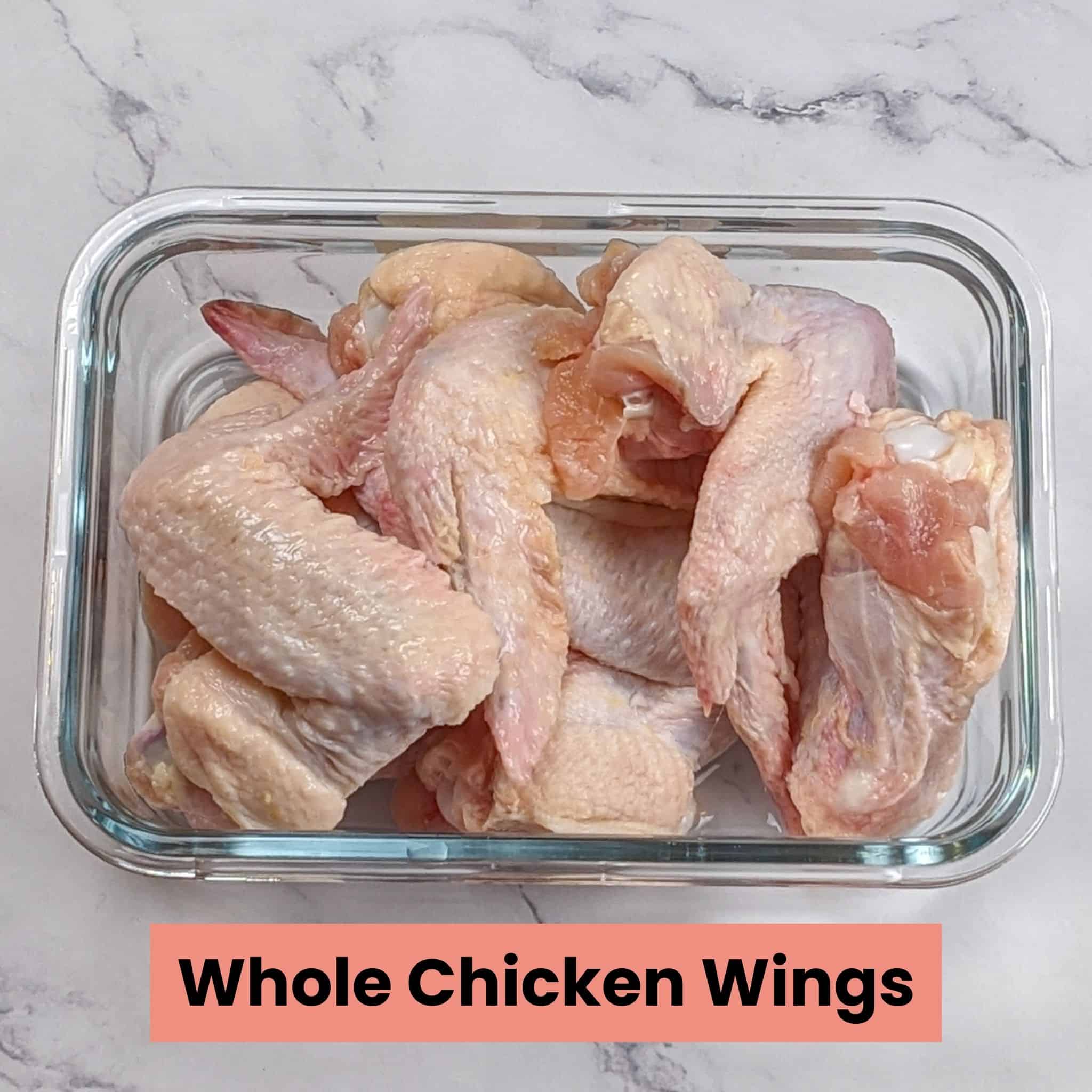 raw whole chicken wings in a rectangle glass dish