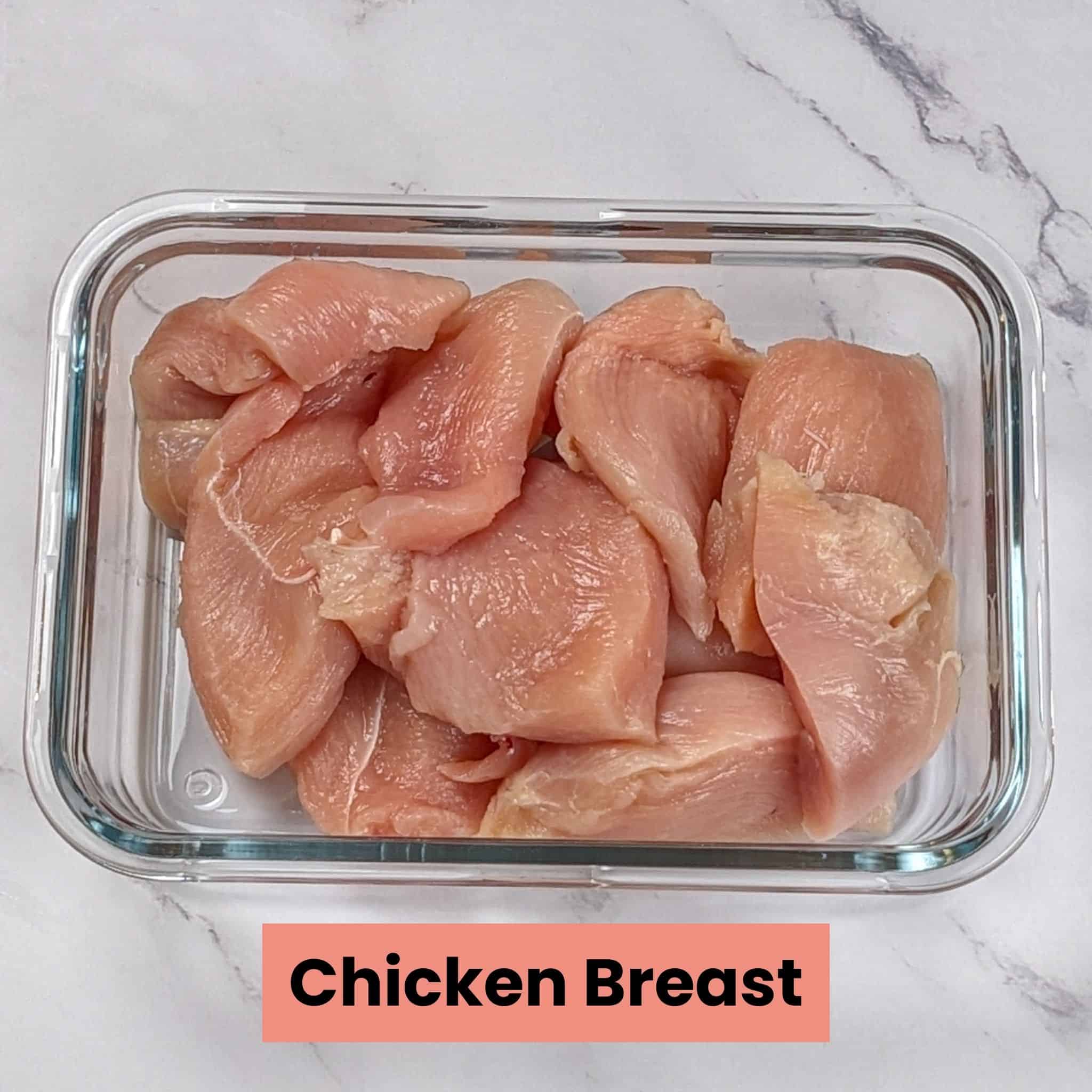 sliced boneless skinless chicken breast in a square glass container.