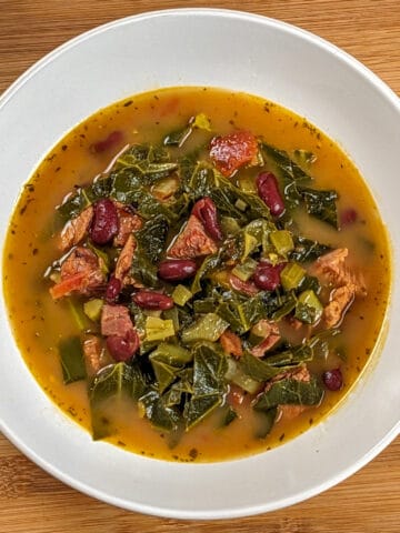 Top view of the Scotch Bonnet Smoked Turkey Collard Greens Beans Soup in a wide rim bowl