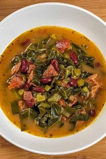 Top view of the Scotch Bonnet Smoked Turkey Collard Greens Beans Soup in a wide rim bowl