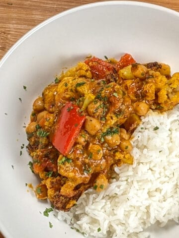 top view of the Air Fryer Roasted Chicken Chickpeas Vegetable Curry recipe in a wide rim bowl with basmati rice.