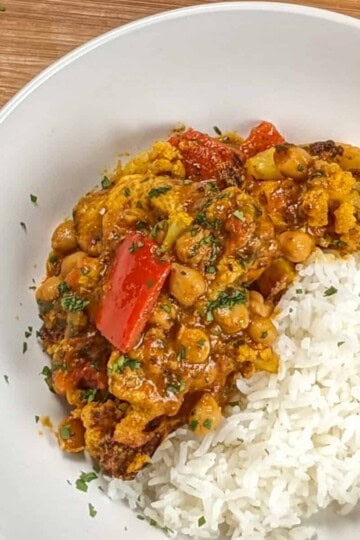 top view of the Air Fryer Roasted Chicken Chickpeas Vegetable Curry recipe in a wide rim bowl with basmati rice.