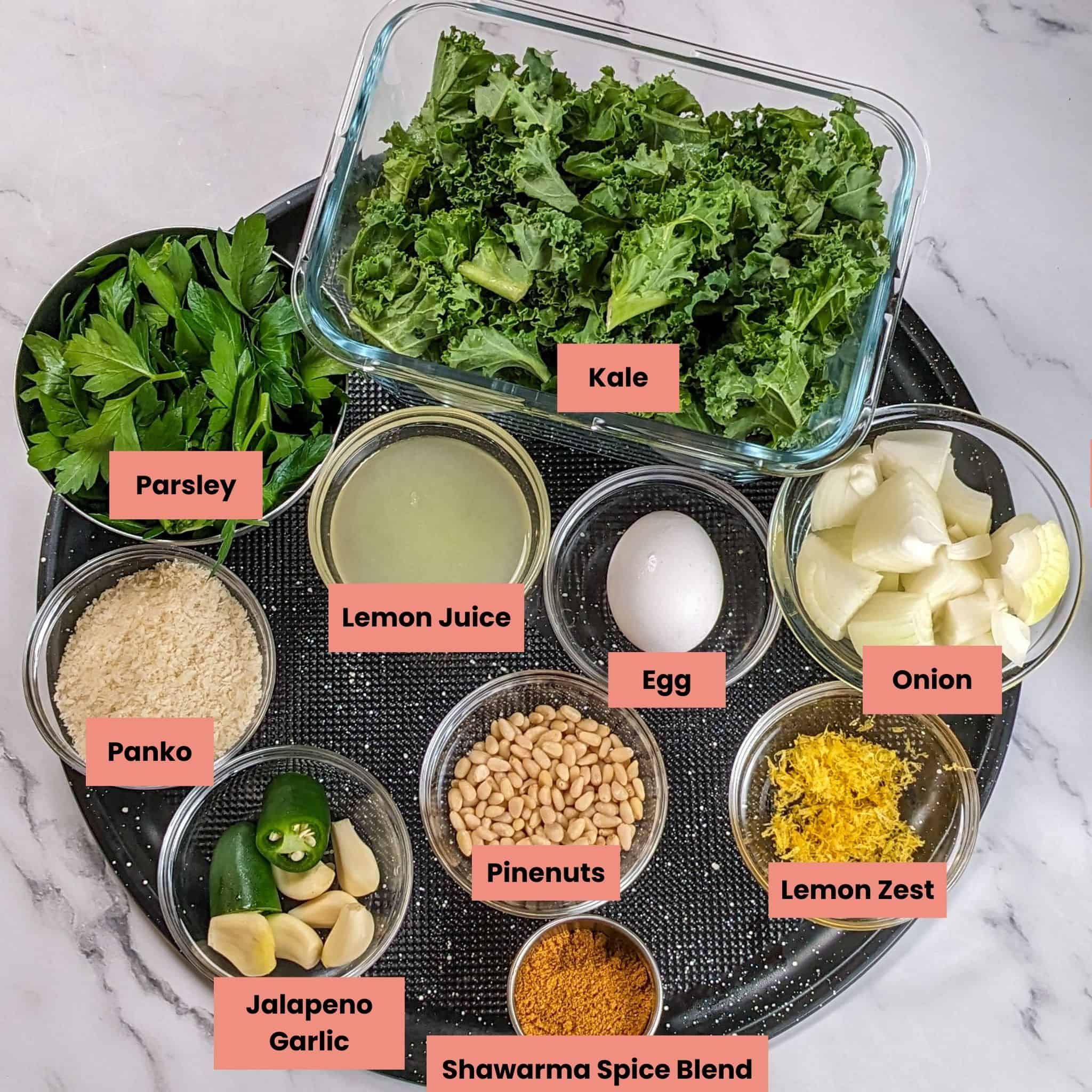 ingredients for the Spicy Turkey Meatball Kale Soup in containers on a large round pizza pan.