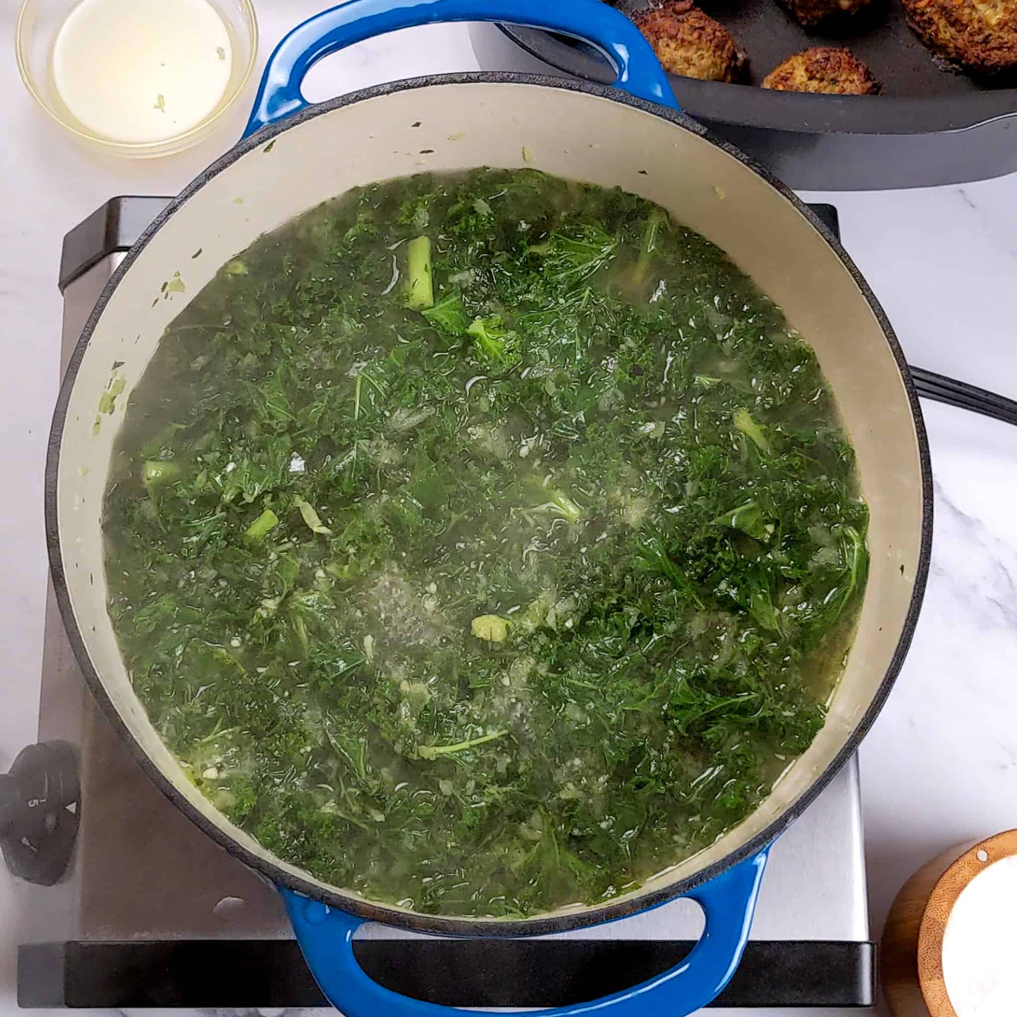 kale simmering in broth in a dutch oven