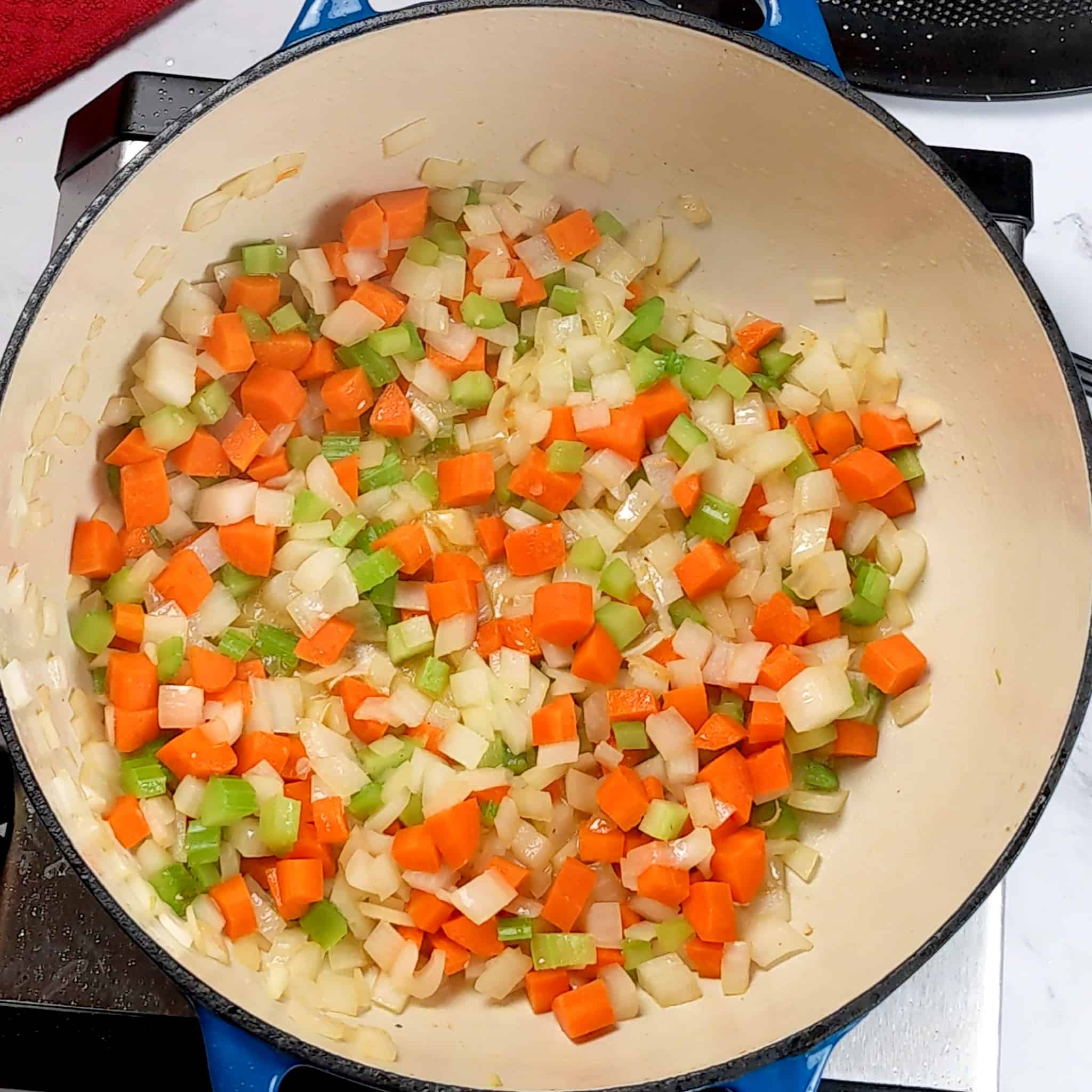 sautéed small diced carrots, onion and celery combined in a pot